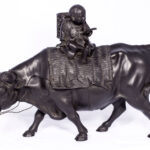 LARGE JAPANESE BRONZE OKIMONO OF A BOY SEATED UPON AN OXEN