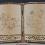 A DELIGHTFUL JAPANESE IVORY TWO FOLD TABLE SCREEN