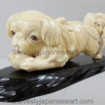 A CHARMING JAPANESE IVORY OKIMONO OF A PEKINGESE DOG