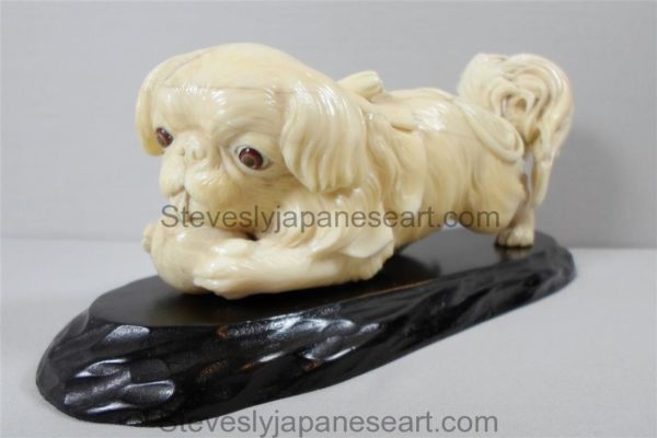 A CHARMING JAPANESE IVORY OKIMONO OF A PEKINGESE DOG