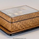 A JAPANESE SILVER MOUNTED AND BASKET WEAVE TRINKET BOX ON STAND
