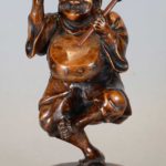 JAPANESE WOODEN OKIMONO OF A DANCING DRUMMER BOY