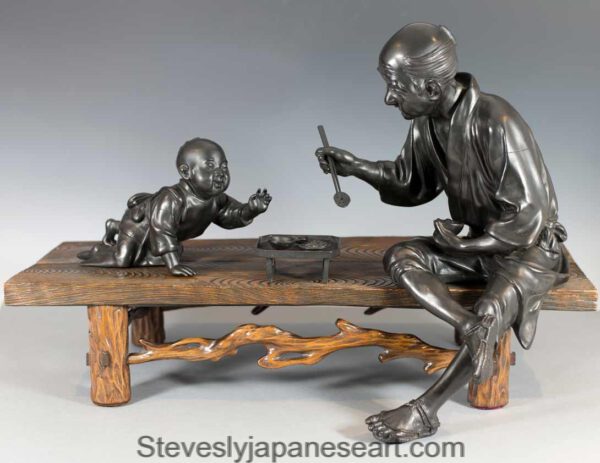 A Charming Japanese Bronze Okimono  Father Feeding Child -Takaaki.