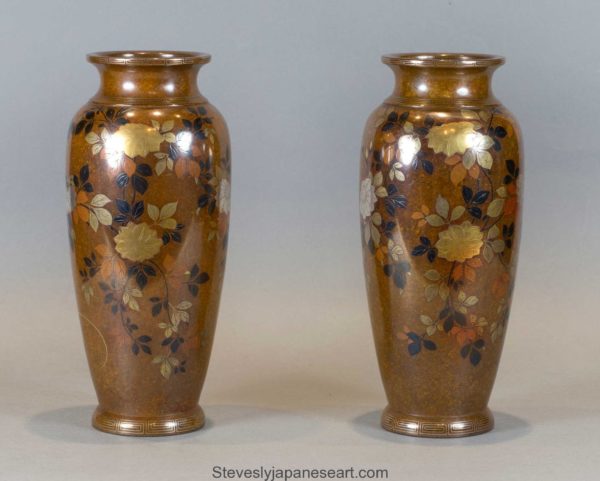 A DECORATIVE PAIR OF JAPANESE INLAID MIXED METAL VASES BY NOGAWA COMPANY