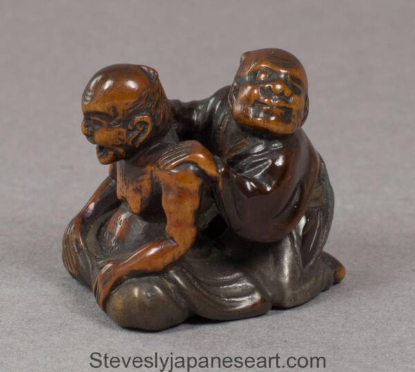 JAPANESE EDO PERIOD WOOD AND LACQUER NETSUKE OF THE BLIND MASSEUR