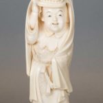 A CHARMING JAPANESE IVORY OKIMONO OF A BOY PERFORMING A LION DANCE