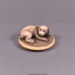 A CHARMING JAPANESE EDO PERIOD IVORY NETSUKE - MONKEY UPON ON A ZABUTON