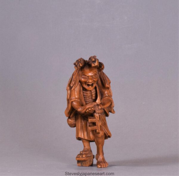 A WELL CARVED JAPANESE CARVED WOODEN NETSUKE - ABURA BOZU - THE OIL THIEF
