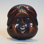 A LARGE AND CHARMING JAPANESE WOODEN NOH MASK NETSUKE OF OKAME - SIGNED